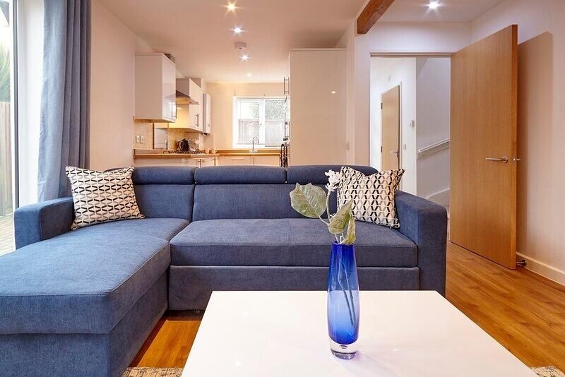Property photo 3 of 12 A Modern And Inviting Living Room Featuring A Spac...