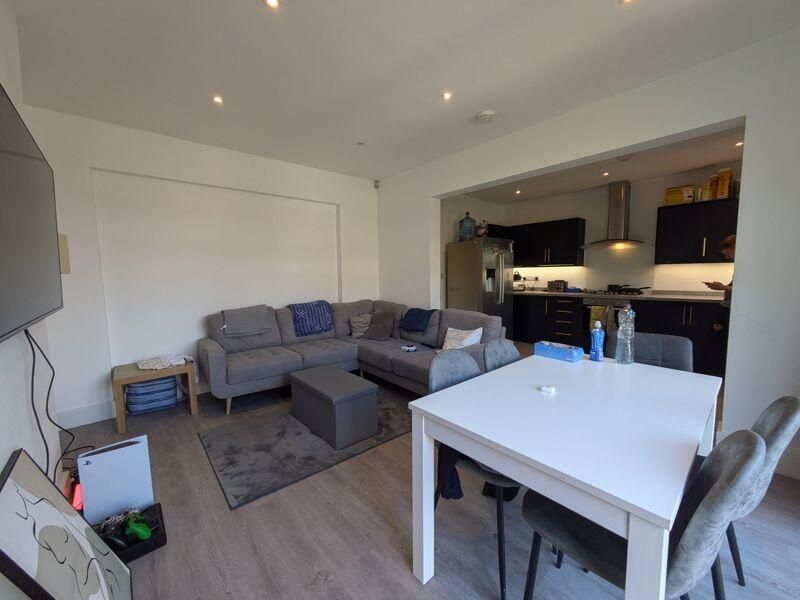 Property photo 3 of 14 A Spacious And Modern Living Room Featuring Comfor...