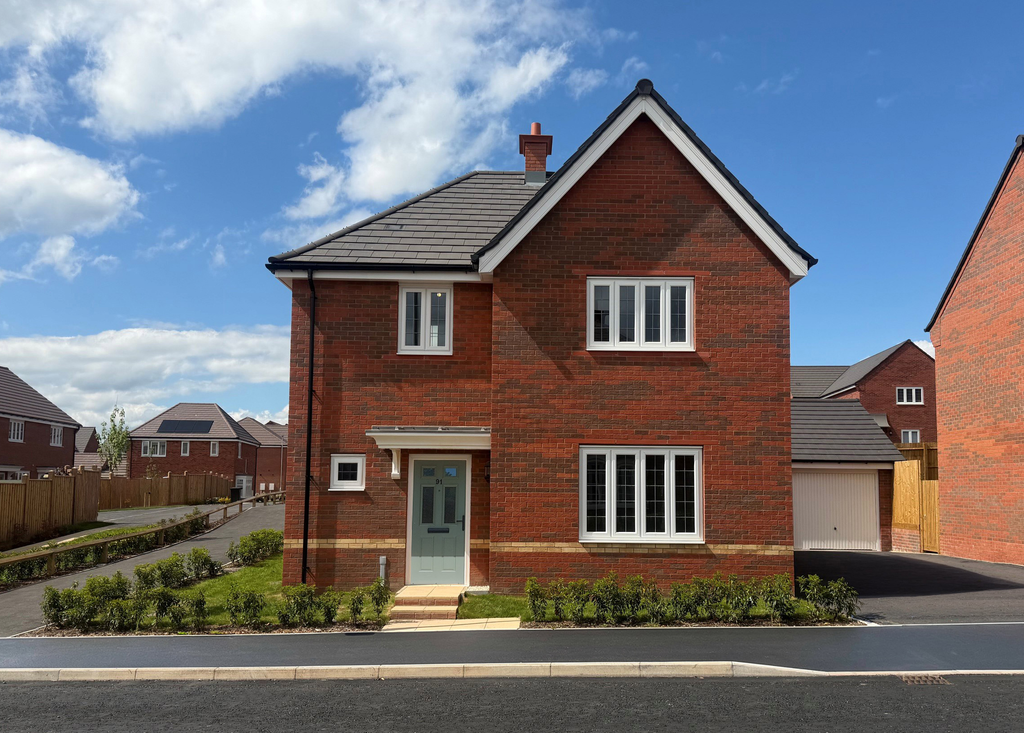 Property photo 1 of 10 A Row Of Modern Brick Houses With Manicured Lawns And Paved Driveways Sits Under A Clear Blue Sky.