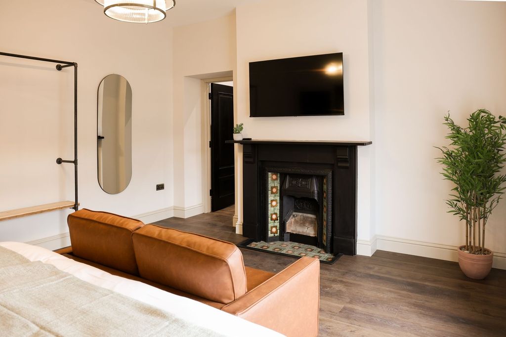 Property photo 3 of 11 Stylish Master Bedroom With Fireplace And TV...