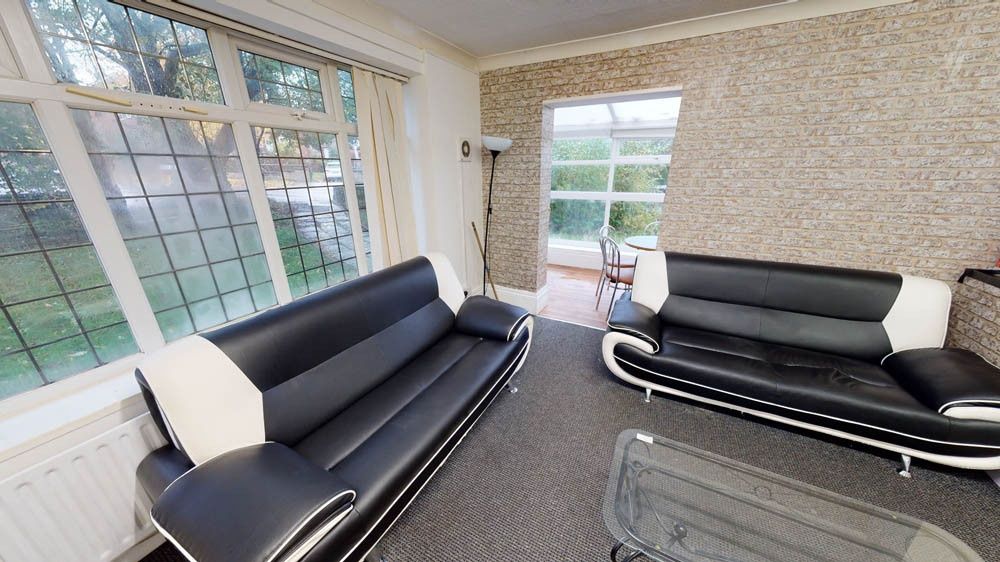 Property photo 3 of 7 A Spacious And Well-Lit Living Room Featuring Mode...