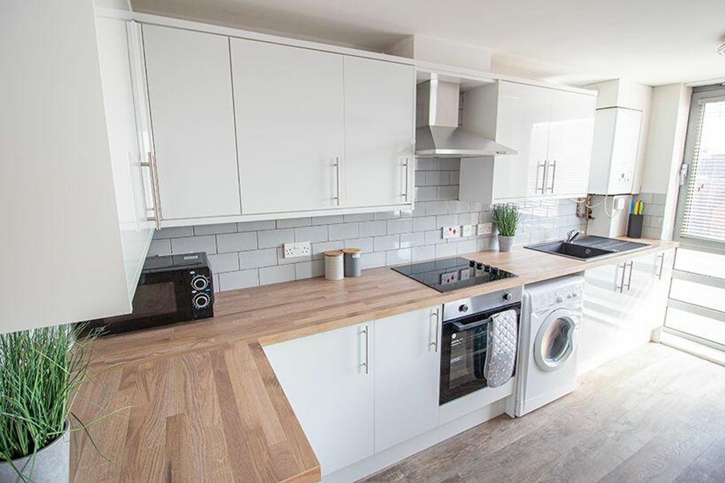 Property photo 2 of 7 This Modern Kitchen Features Sleek Cabinetry, Ampl...