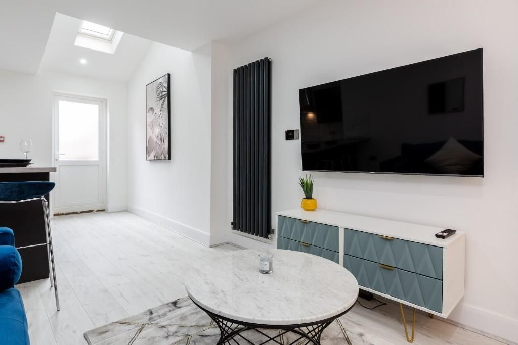Property photo 1 of 10 A Bright And Modern Living Room Featuring A Large ...