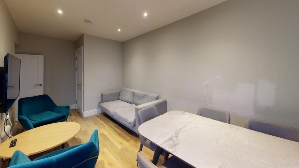 Property photo 1 of 7 A Stylish Living Room Featuring Comfortable Seatin...
