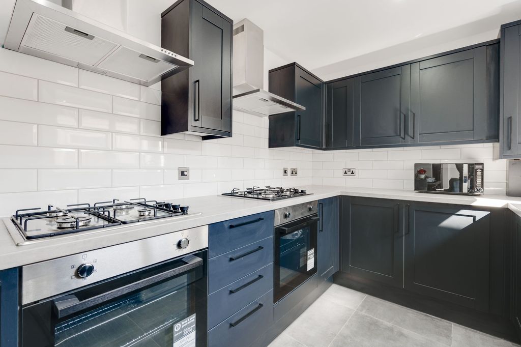 Property photo 2 of 5 Modern Fitted Kitchen With Dark Cabinetry, White S...