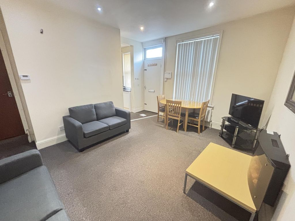 Property photo 2 of 13 A Spacious And Well-Lit Living Room Featuring Comf...