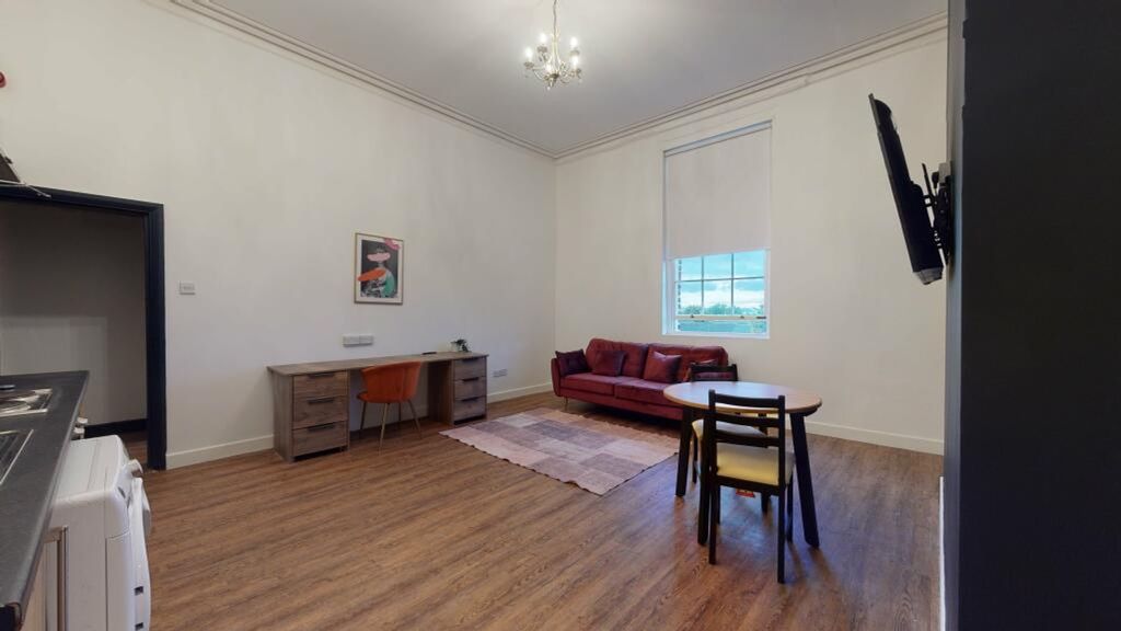Property photo 3 of 5 A Spacious And Modern Living Room With Ample Natur...