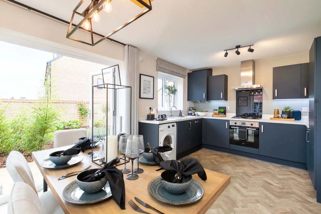 Property photo 3 of 9 A Modern And Stylish Kitchen With Dark Cabinets, A Herringbone-Patterned Floor