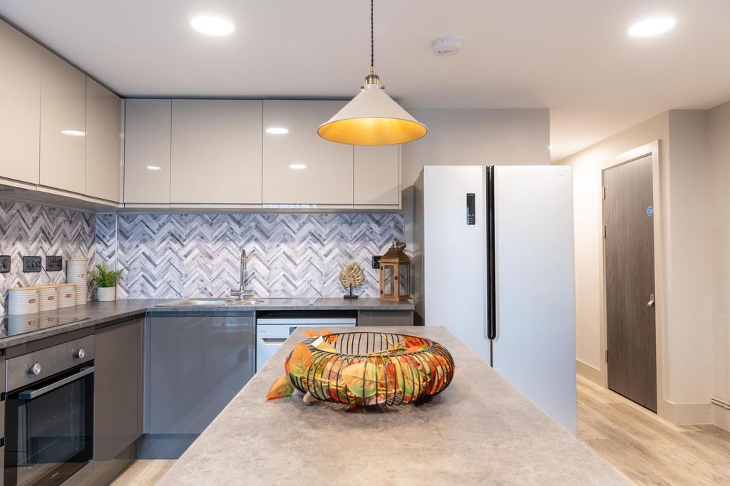 Property photo 1 of 12 Modern Kitchen Featuring A Sleek Design With Gloss...