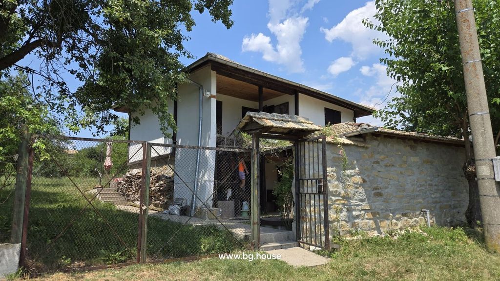 Property photo 1 of 99 Front View Of A Traditional Bulgarian House With A Gated Entrance And Stone Wall Under A Blue Sky