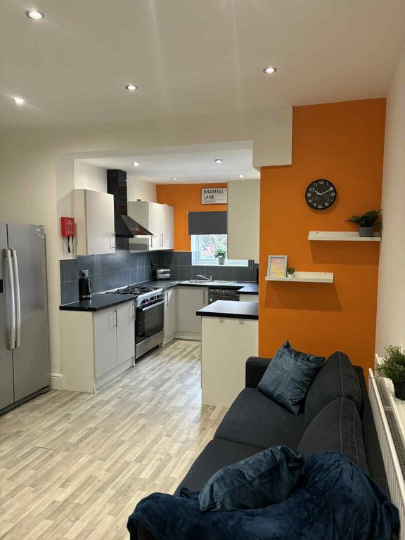 Property photo 1 of 14 A Modern, Well-Lit Living Room Featuring A Cozy Bl...