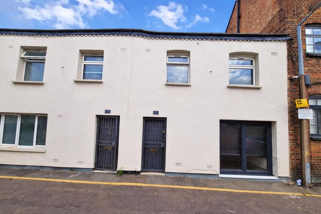 Property photo 1 of 7 White Terraced Building On Quiet Street.Png
