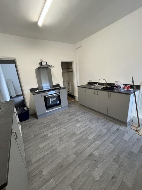 Property photo 2 of 5 A Modern Kitchen Featuring Sleek Grey Cabinets Wit...