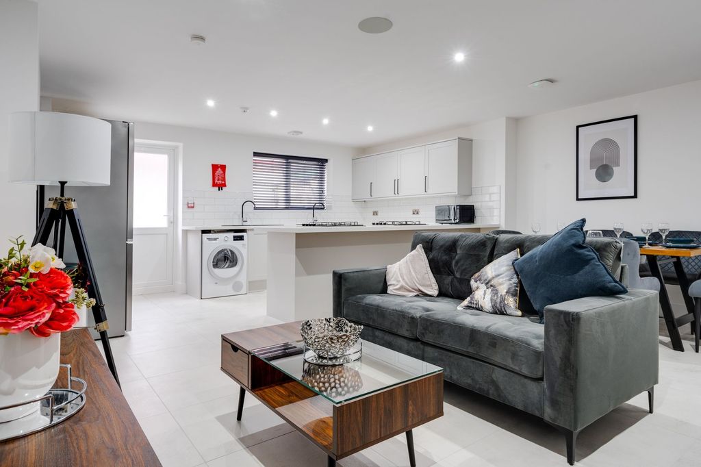 Property photo 1 of 12 Modern And Spacious Living Room Featuring A Comfor...