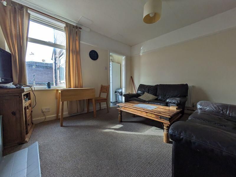 Property photo 2 of 7 A Cozy Living Room Featuring Comfortable Leather S...