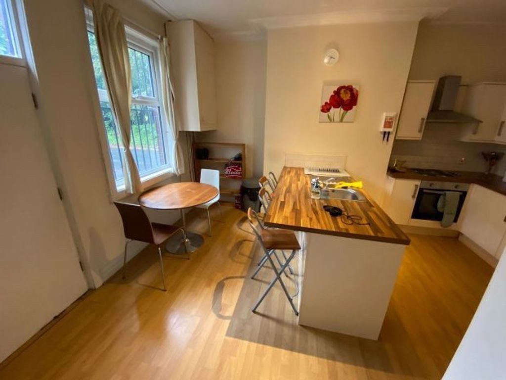 Property photo 3 of 27 Bright And Modern Kitchen Featuring A Central Wood...