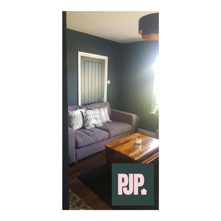 Property photo 1 of 5 A Cozy Living Room Featuring A Comfortable Sofa An...