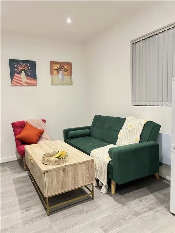 Property photo 3 of 7 A Cozy Living Room Featuring A Stylish Dark Green ...