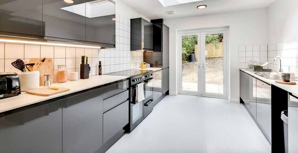 Property photo 3 of 6 This Modern Kitchen Features Sleek Cabinetry, Ampl...