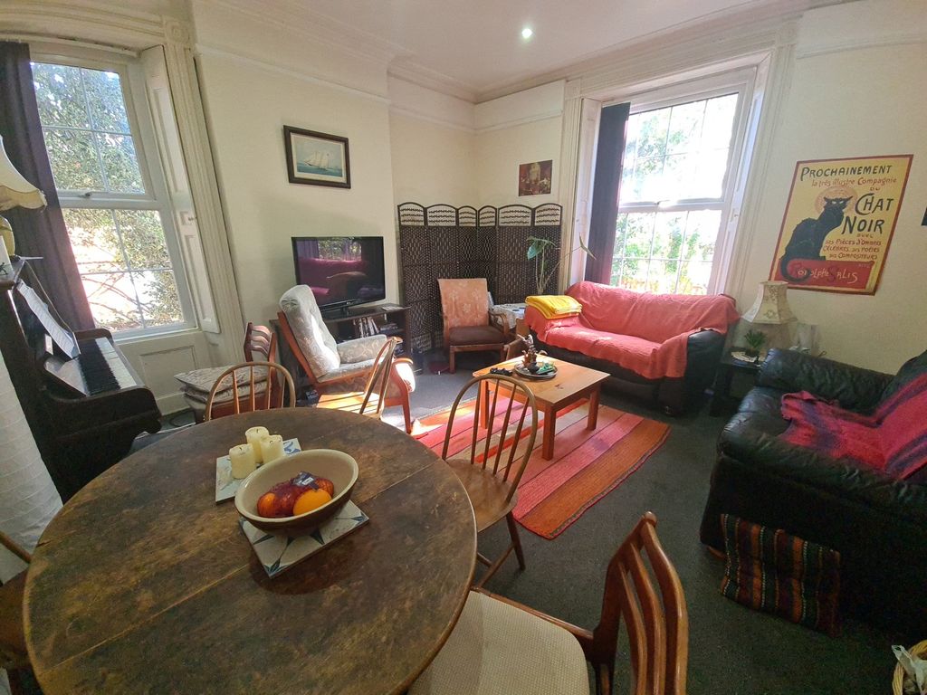 Property photo 1 of 16 A Cozy And Inviting Living Room Featuring Comforta...