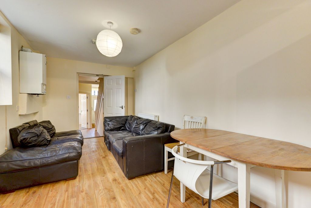 Property photo 1 of 13 A Bright And Inviting Living Room Featuring Comfor...