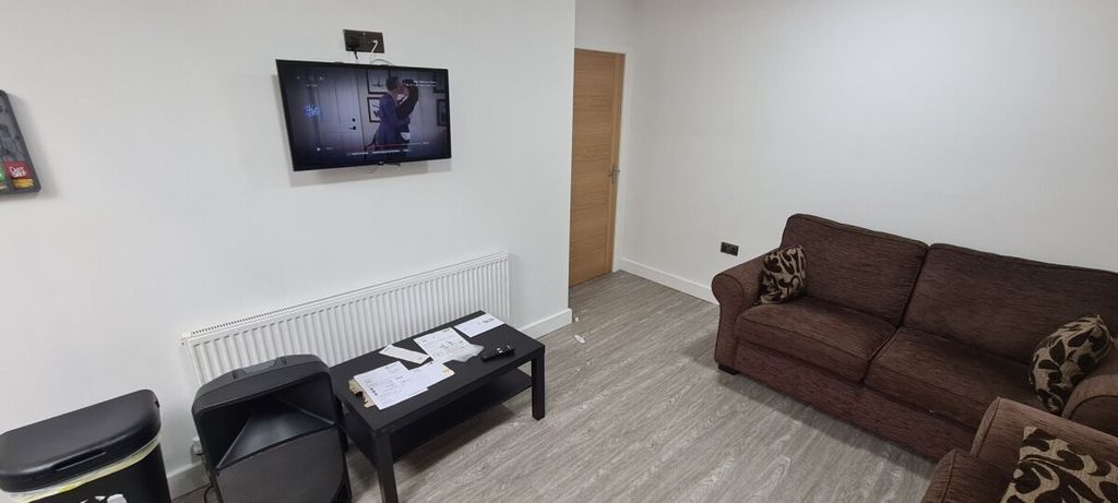 Property photo 2 of 7 A Modern And Inviting Living Room Featuring A Comf...