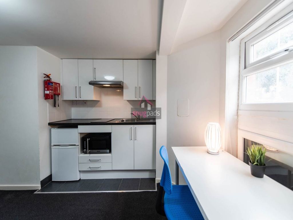 Property photo 2 of 5 Bright And Modern Kitchen Area Featuring Sleek Whi...