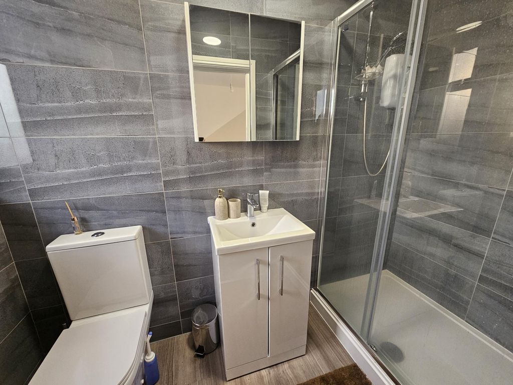 Property photo 3 of 9 Modern Bathroom Featuring A Sleek Glass Shower Enc...