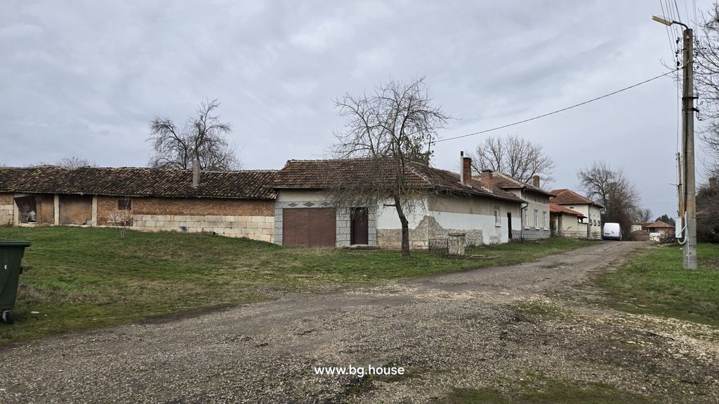 Property photo 1 of 90 View Of A Corner Bulgarian House With Tiled Roof, Stone Base, And Adjacent Buildings At The End Of A Village Street.