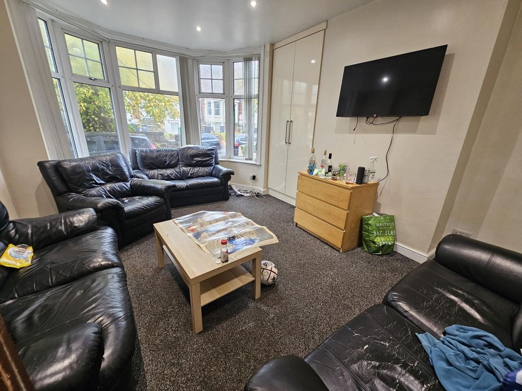 Property photo 1 of 27 A Spacious And Well-Lit Living Room Featuring Comf...