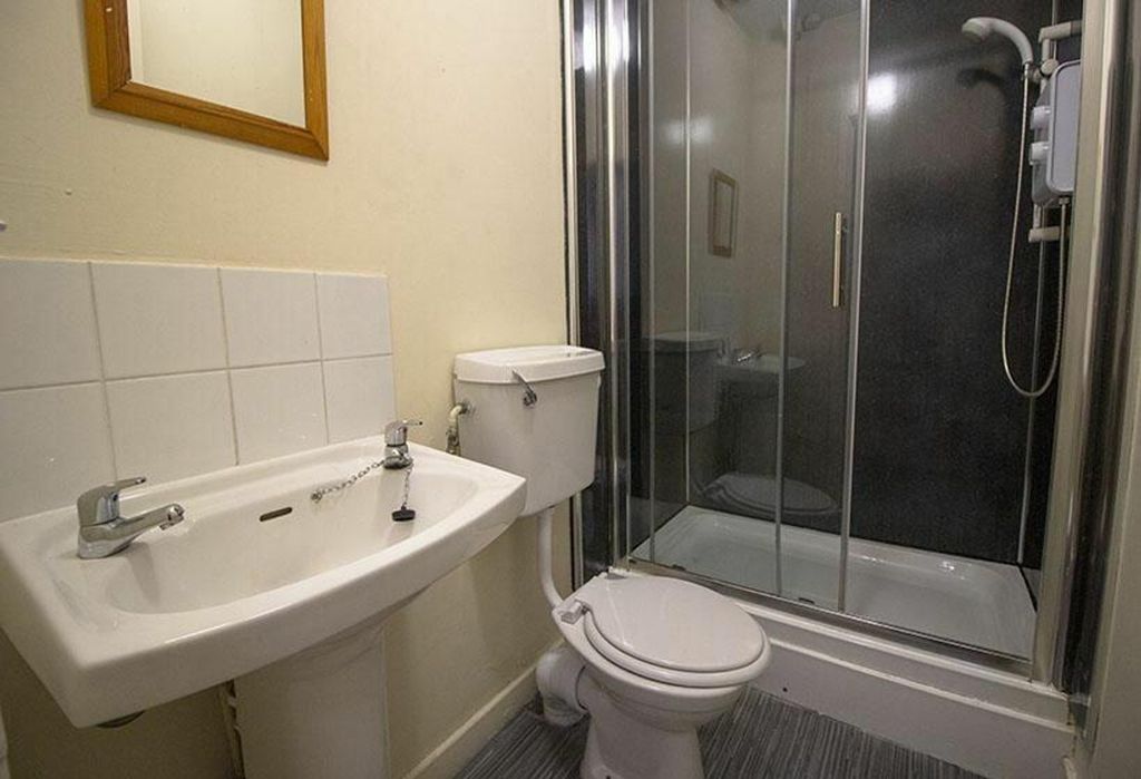 Property photo 1 of 8 This Well-Maintained Bathroom Features A Modern Sh...