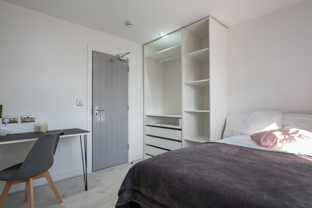 Property photo 1 of 14 A Modern, Well-Maintained Bedroom Featuring A Comf...