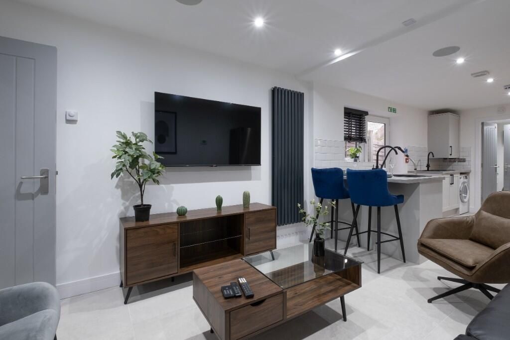 Property photo 3 of 10 Modern And Inviting Living Room Featuring A Sleek ...