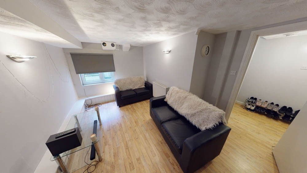 Property photo 2 of 6 A Spacious And Inviting Living Room With Ample Nat...