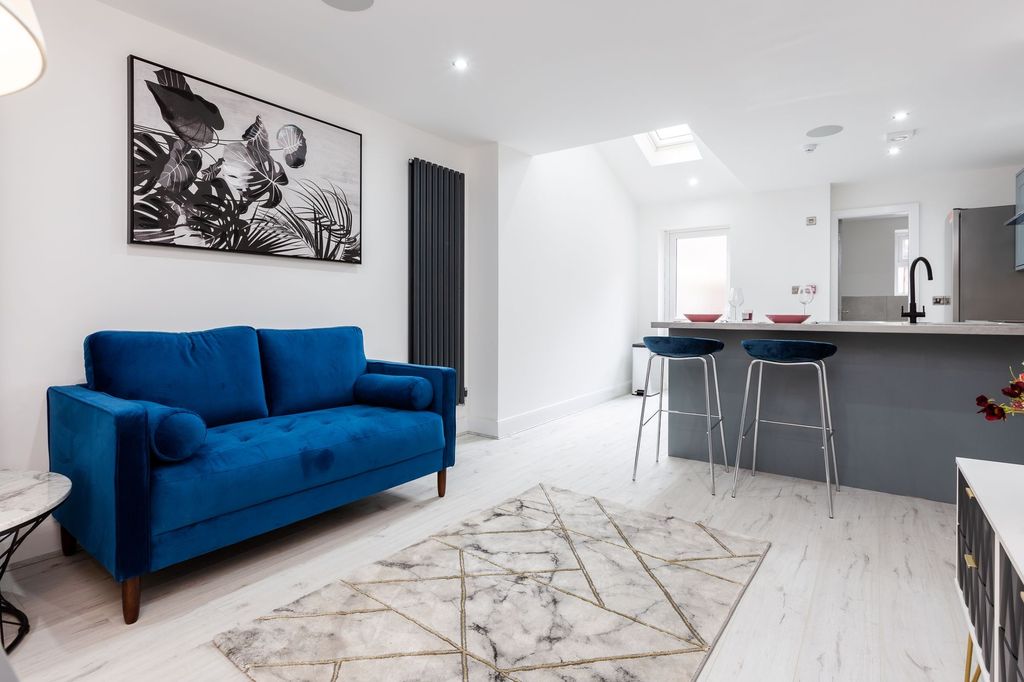 Property photo 1 of 7 Bright And Stylish Living Area Featuring A Vibrant...