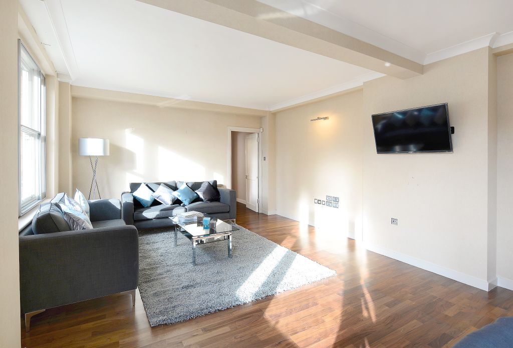 Property photo 3 of 17 This Contemporary Living Room Features Ample Natur...