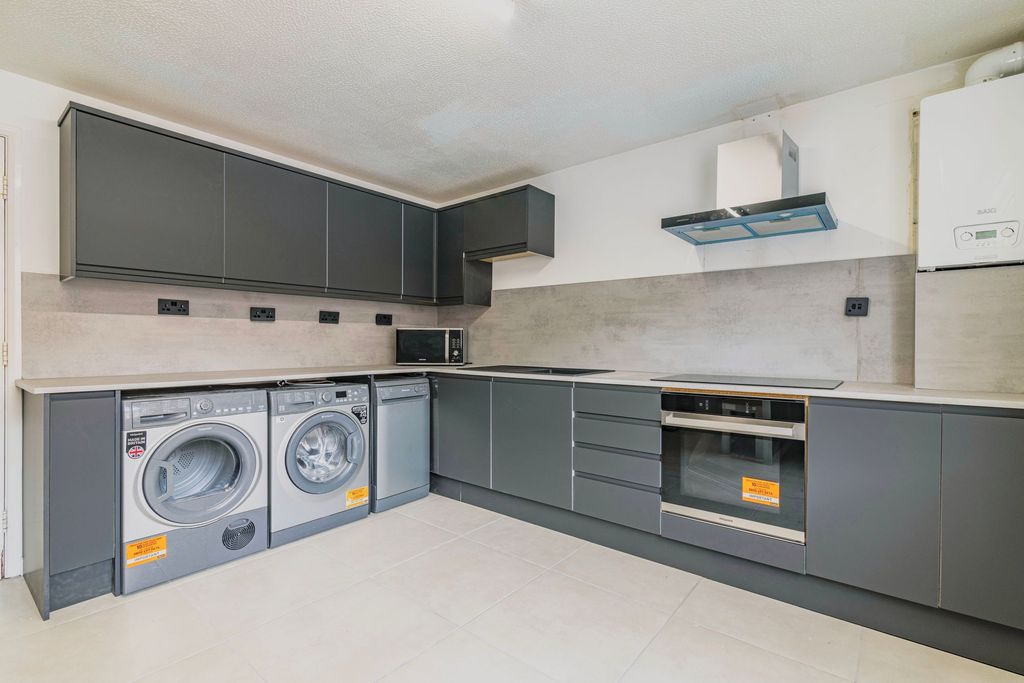 Property photo 3 of 9 Modern Kitchen With Sleek Grey Cabinets, Integrate...