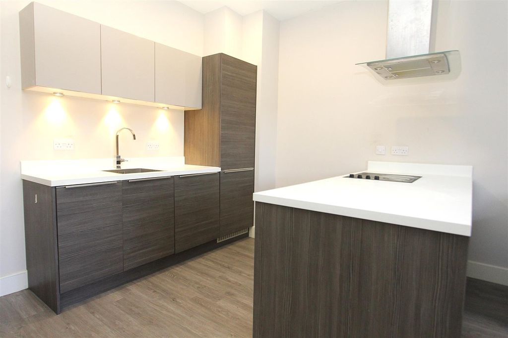 Property photo 3 of 7 Sleek Modern Kitchen With Stylish Wood Cabinets...