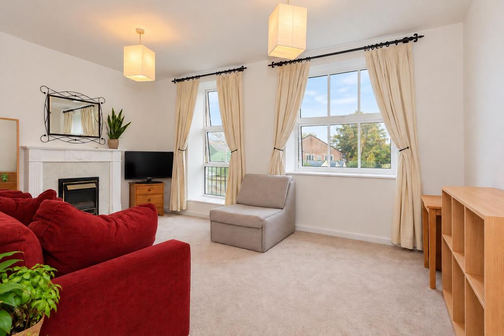 Property photo 1 of 9 Bright Staged Living Room With Red Sofa.Png