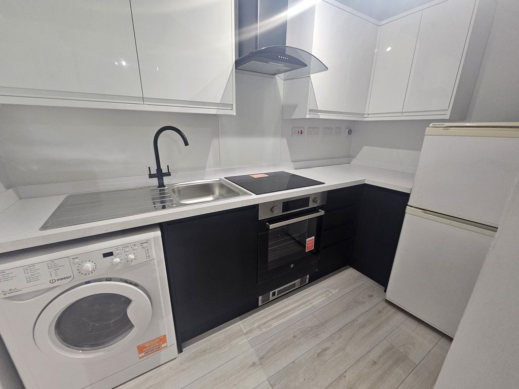 Property photo 3 of 6 Modern Kitchen With Sleek Black And White Cabinetr...