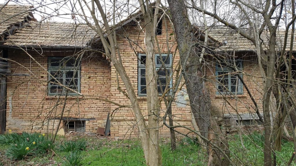 Property photo 2 of 53 Front View Of A Two-Storey Brick House Partially Obscured By Bare Trees