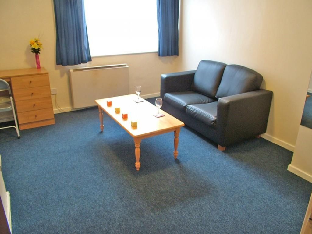 Property photo 1 of 2 A Cozy Living Room Featuring A Comfortable Black S...