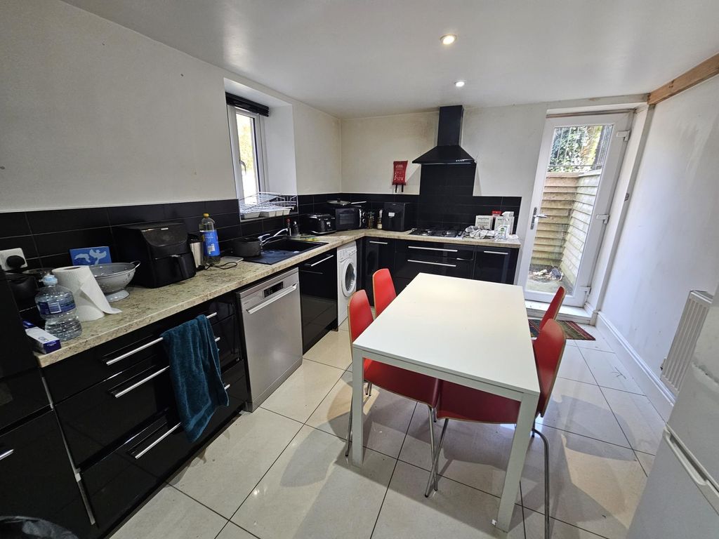 Property photo 3 of 10 A Modern, Well-Lit Kitchen Featuring Sleek Black c...