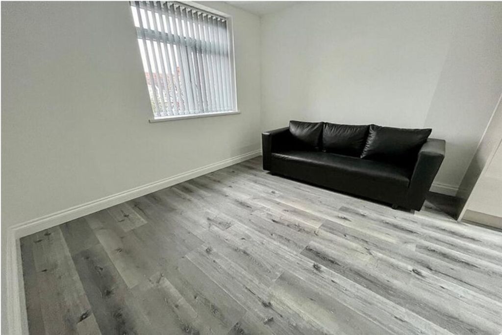Property photo 3 of 6 Bright And Modern Living Room Featuring A Comforta...