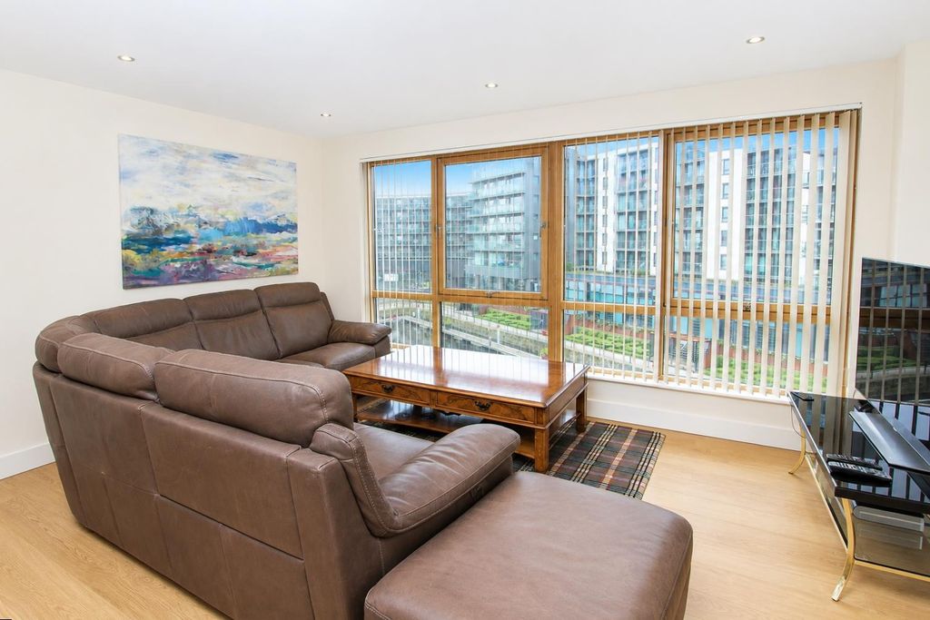 Property photo 2 of 10 Bright Lounge With A Large Sofa And Floor Windows...