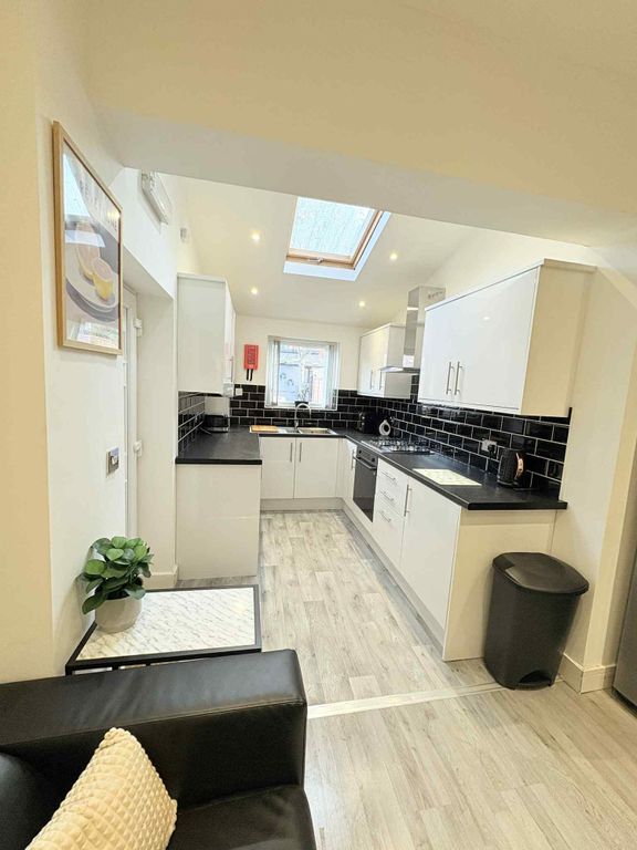 Property photo 2 of 21 Bright Modern Kitchen With White Cabinets, Black c...