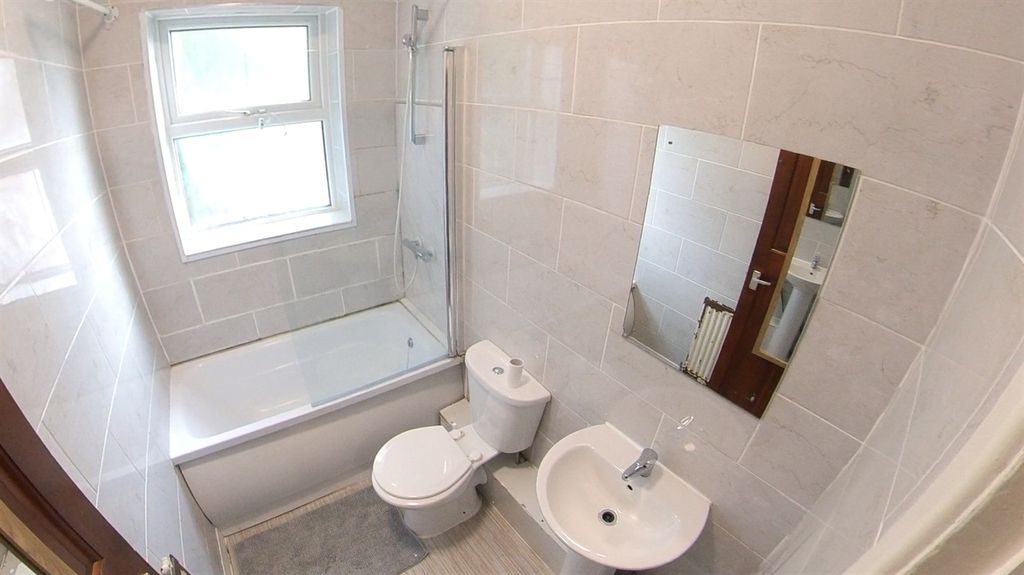 Property photo 3 of 13 A Clean And Modern Bathroom Featuring A Bathtub, T...