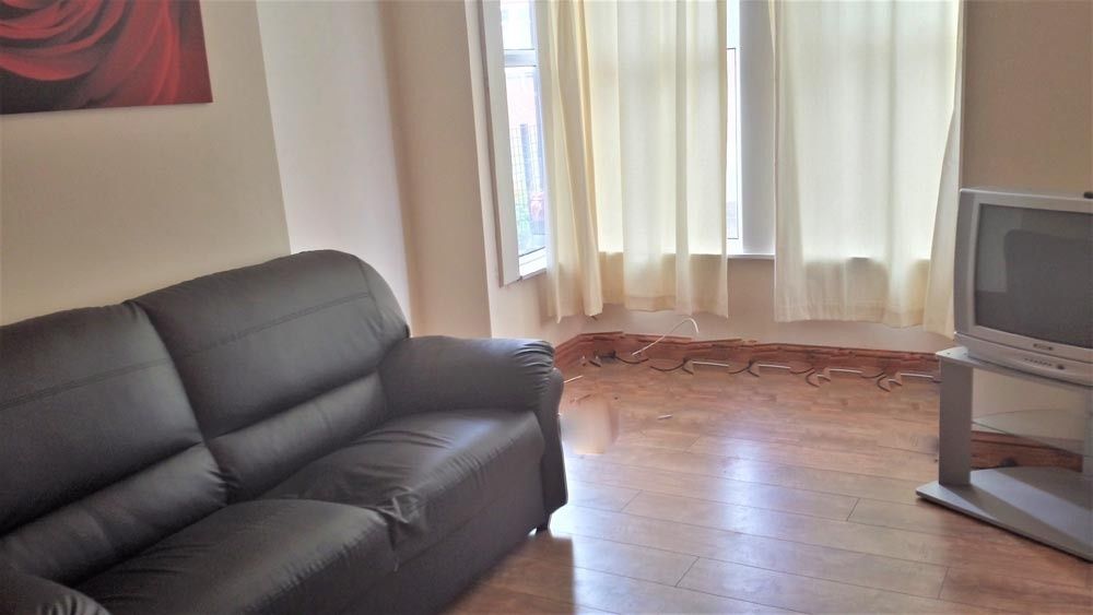 Property photo 1 of 12 Cozy Living Room Featuring A Comfortable Black Sof...