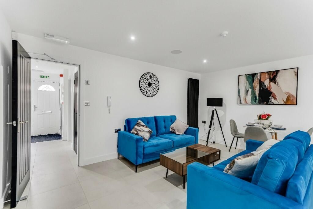 Property photo 1 of 12 Bright And Spacious Living Room Featuring Modern d...