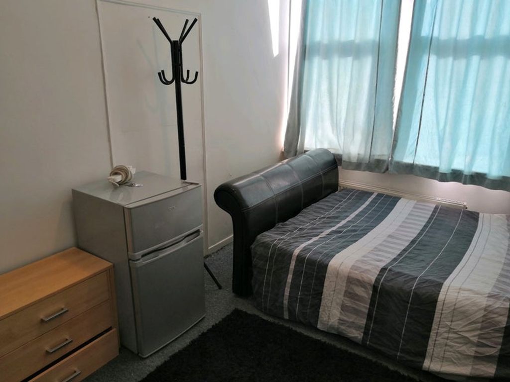 Property photo 3 of 10 A Tidy Double Bedroom Featuring A Bed, A Small Fri...
